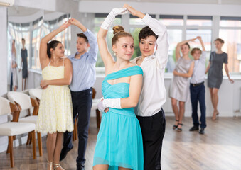 Fototapeta premium Boy and girl dance couples ballroom dance waltz in studio