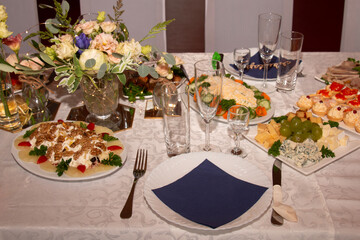 The banquet is festive, beautiful table setting, a table with very tasty meat and fish dishes.