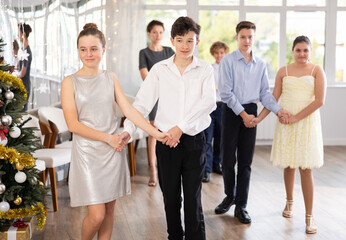 Group of boys and girls dancing folk dance in studio..