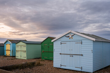 Beach huts on the beach in Shoreham-by-Sea on a winter cloudy day, West Sussex, England

