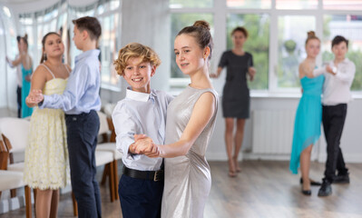 Viennese Waltz performed by teenage girls and boys in a dance studio