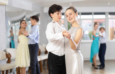During rehearsal of reporting concert, adolescence boy and girl participants of dance workshop...