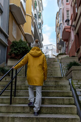 A Vivid Solitary Trek: The Contrast of a Yellow Silhouette Against the Urban Canvas