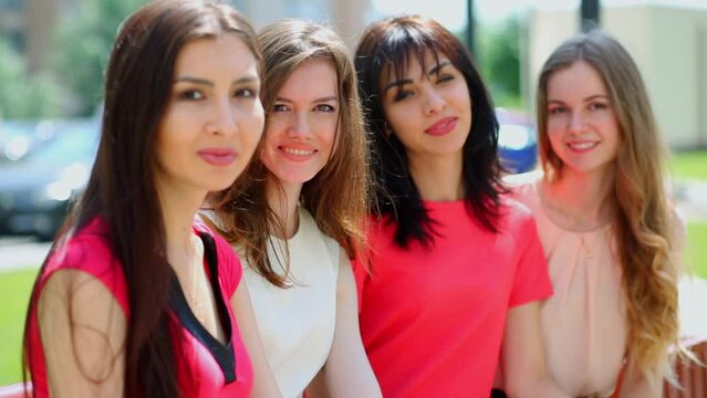 Group of four young women which smiles close together