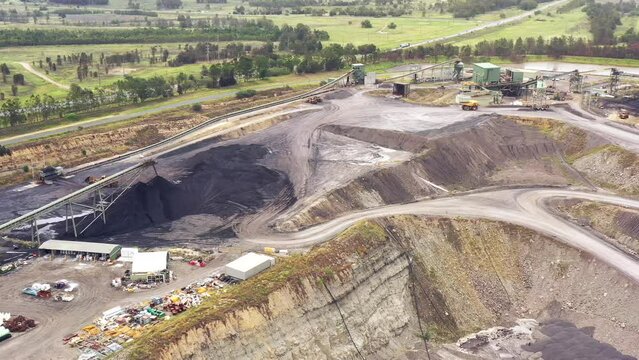 Bowl of deep excavated open pit black coal mine in Hunter Valley of Australia 4k.
