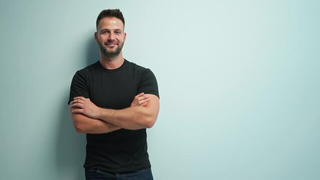 Portrait of happy casual man pointing at blank space, Young guy standing at white wall, Isolated on white background, copy space.