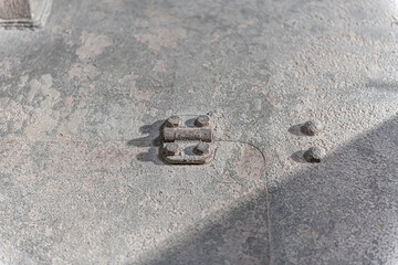 metallic hinge from military tank vehicle