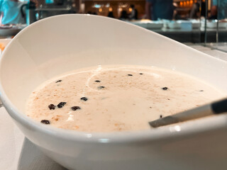 Fresh homemade hot oatmeal and raisins on display for breakfast or brunch. Located within a buffer line on a river cruise ship.