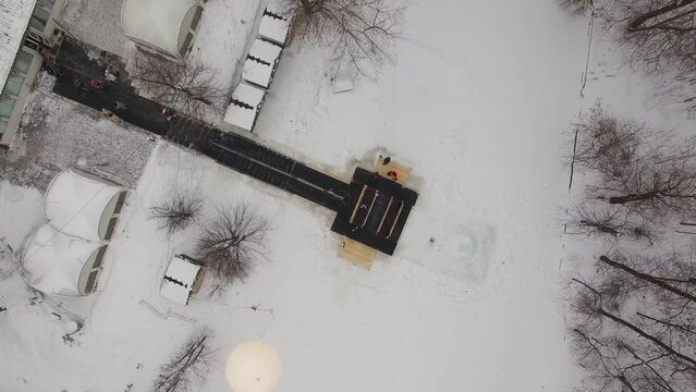 People do baptistery submersion in outdoor pool at winter day