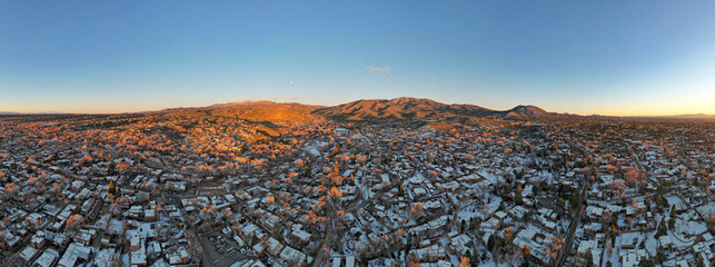 Fototapeta premium Sunset drone photograph above Santa Fe, New Mexico in winter. 