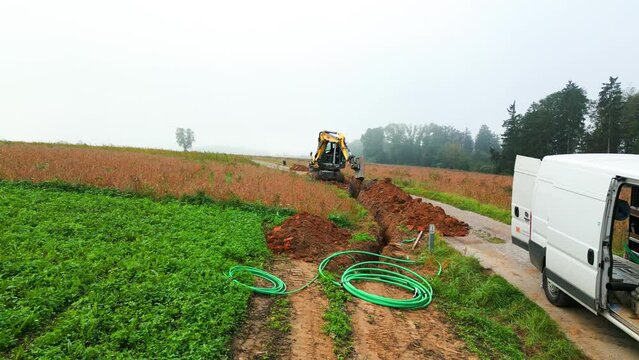 aerial of laying fiber optic cable in rural area