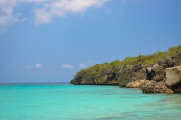 Fototapeta na wymiar Little Knip beach - paradise white sand beach with blue sky and clear azure water in Curacao, Netherlands Antilles, a Caribbean tropical Island.
