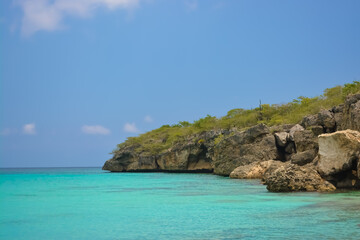 Little Knip beach - paradise white sand beach with blue sky and clear azure water in Curacao, Netherlands Antilles, a Caribbean tropical Island.