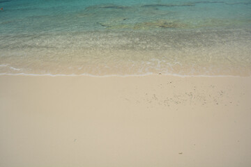 Fototapeta na wymiar Beautiful blue Caribbean sea water with white foam edge. Space for text. 