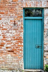 Antique blue European doorway on brick red wall 