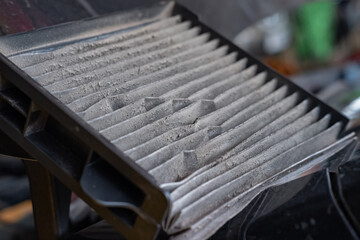 Closed up filthy car's air conditioning filter that needs to be replaced.