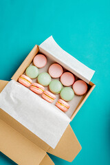 Close up colorful macarons dessert with vintage pastel tones in paper box