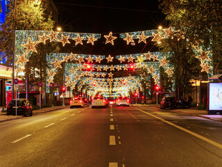 Fototapeta na wymiar Athens, Greece - December 25, 2023: City traffic avenue with Christmas decorations