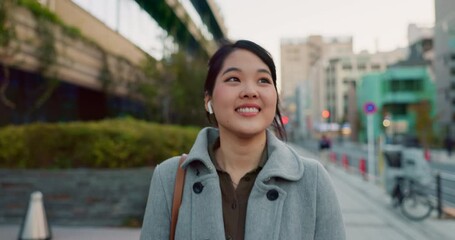 Happy woman, Japanese and earphones, travel in city and commute to work with radio or podcast outdoor. Technology, smile and listening to music on journey, urban street and professional walking