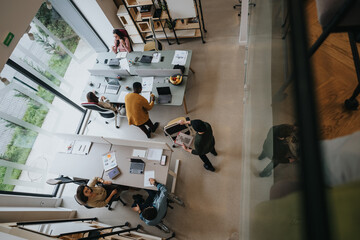 Top-down view of a bustling open-plan office with diverse professionals collaborating at desks and...
