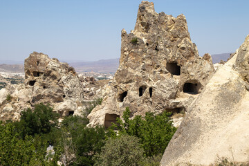 Fototapeta na wymiar This captivating image of Cappadocia’s unique rock formations, with clear signs of ancient habitation, is perfect for educational materials, travel guides, historical publications, and documentaries.