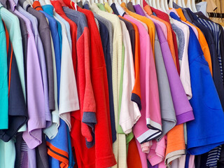 colorful used clothes in thrift stores, used clothing business to reduce clothing waste and reuse...