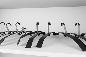 set of full high-end black Metal cloth hangers inside a white Empty wardrobe shelf. 