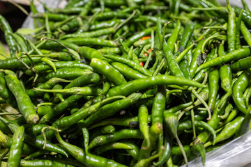 Green small hot chilli at vegetable store for sale at evening