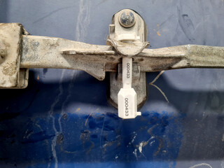 Container door security seal, seal with seal code number to secure goods in shipping.