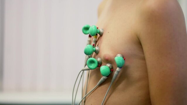 Wires and probes on suckers stick to young boys chest