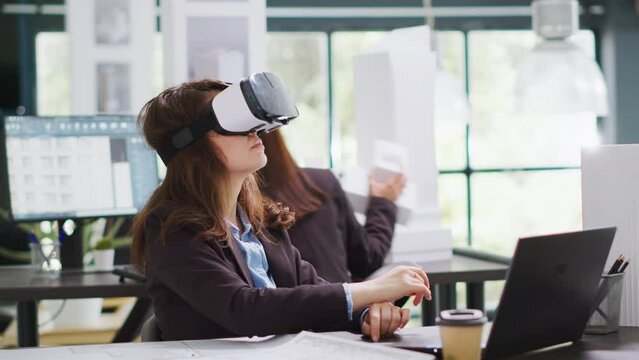Architect designing project blueprints and plans with vr headset, using artificial intelligence to shape new property layout. Specialist working with virtual reality glasses at real estate agency.