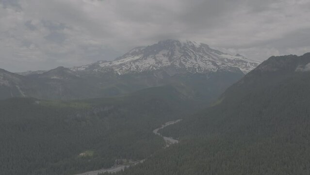 Ungraded 4k wide-angle aerial footage of Mt. Rainier partially obscured by clouds.