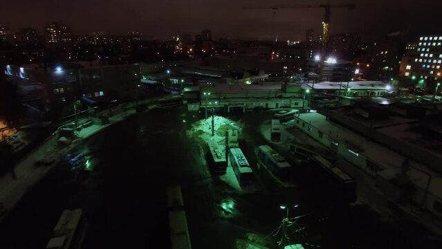 Trolleybus depot with transport and townscape at winter evening