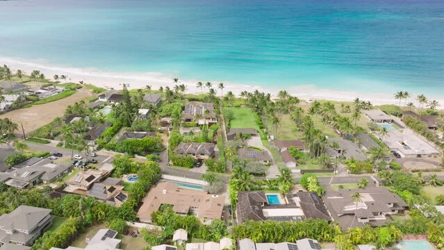 Aerial over ocean front properties with cinematic Hawaii Island views. Real estate business sale copy background. Expensive beach villas and cottage in Kailua town. Luxury rich lifestyle Oahu USA 4K