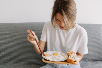 Portrait of asian woman eating her simple and easy breakfast.
