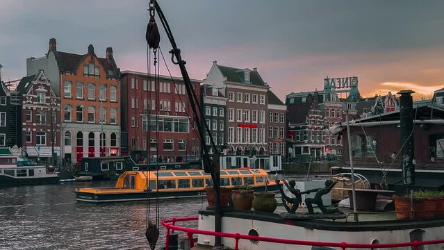 Traditional old narrow houses boats and canals in Amsterdam, Netherlands, Europe, January 20, 2024. High quality 4k footage