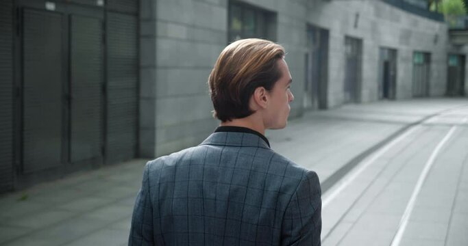 Man in elegant suit strides with certainty on deserted streets captured from back Elegant posture speaks volumes of his composure. Every step radiates elegance of confident free spirit.