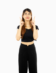 Obraz na płótnie Canvas Young asian woman posing fingers pointing up standing isolated on white background.
