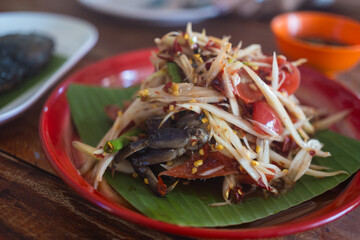 Papaya salad with crab, fermented fish. Thai papaya salad or what we call Somtum. The famous local...
