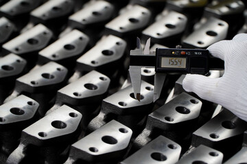 vernier caliper digital,production quality control,Engineer's hand measuring metal parts with...