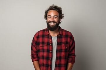 Portrait of a handsome young hipster man smiling at the camera - obrazy, fototapety, plakaty