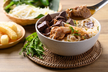 Northern Thai food (Kanom Jeen Nam Ngeaw), Spicy rice noodles soup with pork and pork blood eating with fresh vegetables