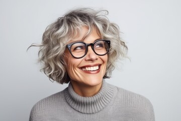 Portrait of a beautiful middle-aged woman with grey hair wearing glasses - obrazy, fototapety, plakaty
