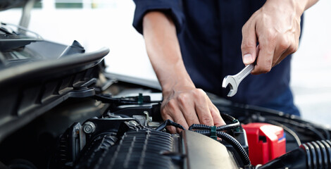 Mechanic are using the wrench to repair and maintenance auto engine at car repair shop,Car auto services and maintenance check concept. - obrazy, fototapety, plakaty