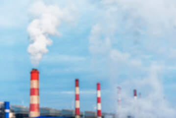 Fototapeta na wymiar Blurred background Power stations electrical industrial plant. Blurry Electric power building refinery engineering steam smokestack. Defocused Lignite electricity chimney release pollution background
