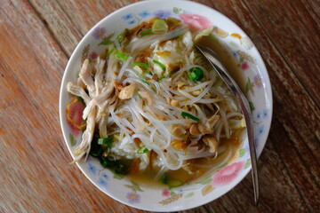 Soto Ayam is a traditional Javanese chicken soup with clear soup. made from chicken, spices, chicken stock, boiled bean sprouts, vermicelli and a sprinkling of fried shallots. Indonesian food. 