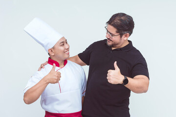 An asian chef together with his boss, the restaurant owner, making thumbs up signs. Isolated on a...