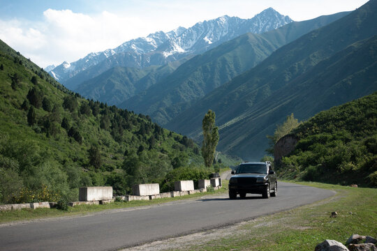 Bishkek, Kyrgyzstan - MAY 22, 2023: Road in Kyrgyzstan mountains with SUV car