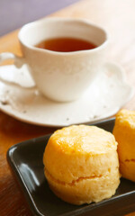 Closeup of a Delectable Scone with Blurry Tea Cup in the Backdrop