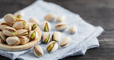 Roasted pistachios on a wooden plate